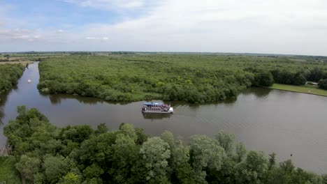 Aerial-Drone-Footage-of-a-ferry-touring-the-Malthouse-Broad,-Ranworth,-Norfolk
