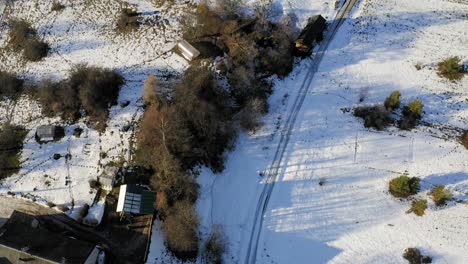 Flying-upwards-over-small-village-during-winter