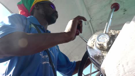 Captain-at-the-helm-of-water-taxi-navigates-under-tropical-sun