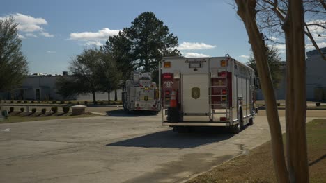 Two-fire-engines-drive-out-of-a-driveway-after-an-emergency-response