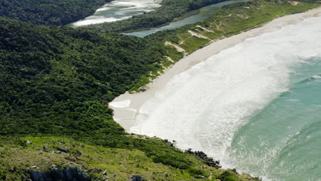 Circling-aerial-view-of-Lagoinha-Do-Leste-beach-shore,-Florianopolis,-Santa-Catarina,-Brasil