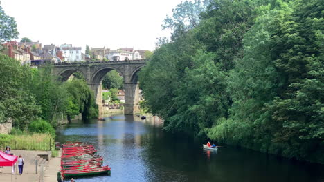 Train-Crossing-Victorian-Viaduct-with-Rowing-Boats-in-Foreground