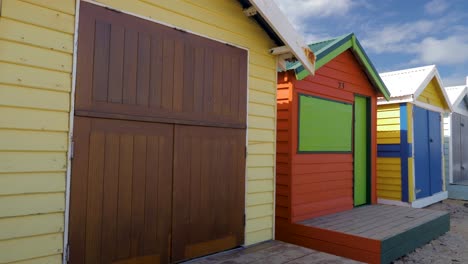 Tourists-walking-and-taking-photo-at-Brighton-Bathing-Boxes,-Melbourne,-Australia