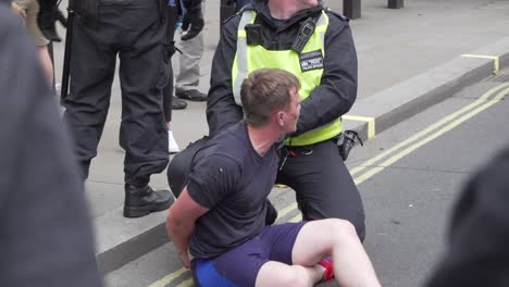 A-Tommy-Robinson-supporter-is-arrested-by-police-along-Whitehall,-London