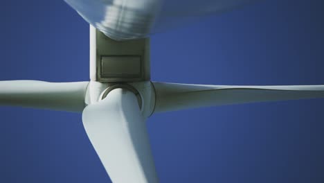 Afternoon-underneath-perspective-with-closer-view-footage-from-a-wind-turbine-machine-and-its-rotating-blades