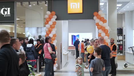 Opening-new-xiaomi-store,-people-are-waiting-in-a-long-line,-slowmo