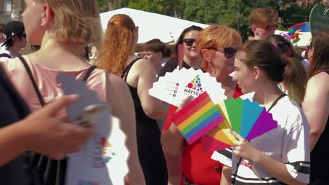 Colorful-people-getting-ready-to-march-in-the-Budapest-Pride,-beautiful-people-with-rainbow-fans