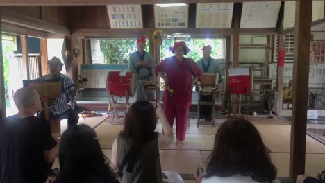 Japanese-lady-dancing-to-traditional-Okinawan-folk-music-in-a-tatami-teahouse