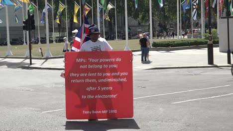 A-protester-hold-a-sign-showing-support-for-democracy-in-the-UK-and-reminding-Boris-Johnson-of-his-responsibilities