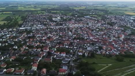 Panning-aerial-view-of-Strahlenburg-ruin-in-Schriesheim-Germany-with-view-of-city-below