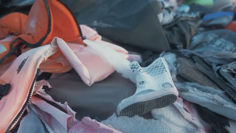 Child's-welly-refugee-lifejacket-graveyard-Lesvos,-Greece