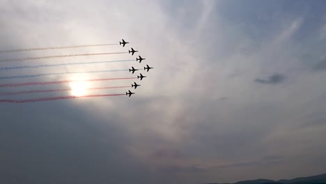 Eight-professional-pilots-showing-their-skills-flying-on-the-sky-leaving-colorful-clouds-behind-their-planes