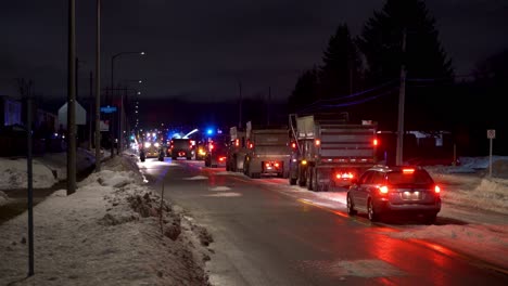 Un-Convoy-De-Camiones-Volquete-Esperando-Para-Cargar-Nieve-Durante-La-Remoción-De-Nieve-De-La-Ciudad-Por-La-Noche