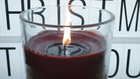 A-glassed-candle-burning-in-the-foreground---Time-lapse