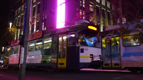 Melbourne-CBD-busy-intersection-nighttime-Melborune-busy-traffic-at-nighttime-with-tram,-cars-and-pedestrians