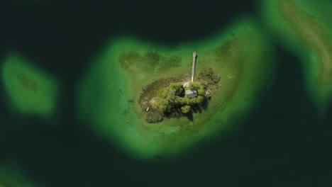 Isolated-island-Maximiliansinsel-in-German-lake-Eibsee,-aerial-drone-view