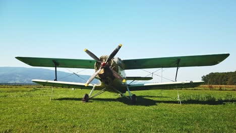 Russian-Antonov-An-2-on-grass-airfield,-vintage-Soviet-propeller-airplane