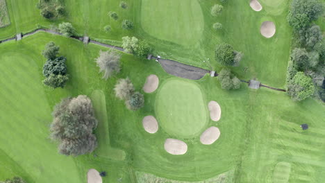 An-aerial-view-of-one-one-the-greens-and-some-of-the-bunkers-at-Turriff-Golf-Club,-Aberdeenshire
