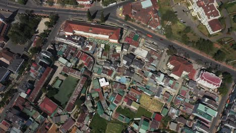 Top-down-drone-shot-of-key-buildings-and-lake-in-the-city-center-of-Da-Lat-or-Dalat-in-the-Central-Highlands-of-Vietnam-on-sunny-day