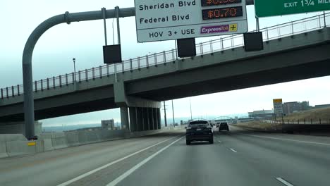 Slow-motion-POV-of-express-road-sign-in-Denver,-Colorado