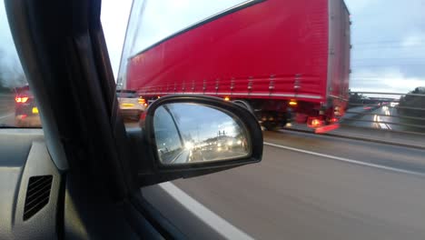 Overcast-morning-commute-time-lapse-UK-speeding-traffic-side-view-mirror-perspective