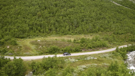 Black-Car-Travelling-On-The-Mountain-Road-In-Hemsedal,-Norway---aerial-side-shot