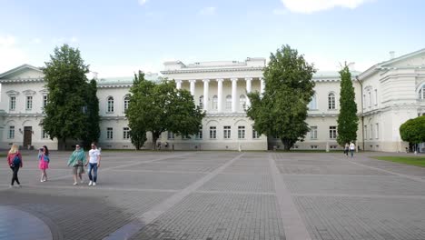 Facade-of-Vilnius-presidiantial-palace-while-lovely-couple-walks-around