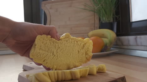 Cut-Croissant-Bread-On-A-Wooden-Board-In-The-Kitchen---extreme-slow-motion