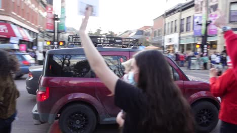 People-celebrating-Joe-Biden's-election-victory-in-the-streets-of-Boulder,-Colorado