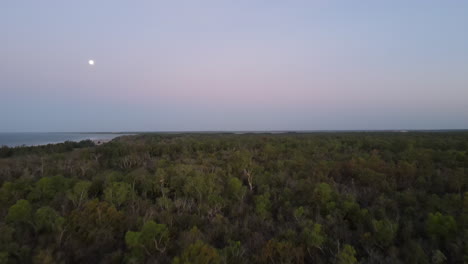 Low-drone-shot-moving-towards-moon-at-Lee-Point-Darwin,-Northern-Territory