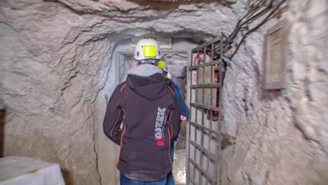 Group-of-young-people-explore-tunnels-of-deactivated-mine