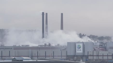 Paper-Mill-Factory-surrounded-by-smog-emissions-on-Foggy-Cold-day---Wide-static-shot