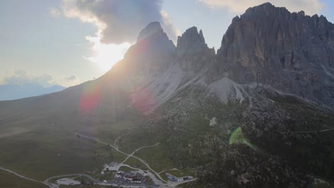 Aerial-view-of-Dolomites-peak-in-Val-Gardena,-Italy,-with-sun-flare