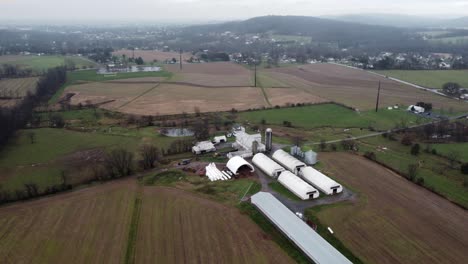 Denver,-Pennsylvania---November-26,-2020:-An-aerial-view-of-a-farm-and-the-surrounding-farmland-in-Lancaster-County,-Pennsylvania