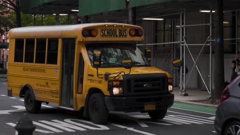 Yellow-School-Bus-on-Streets-of-Downtown-Manhattan,-New-York-USA,-Slow-Motion