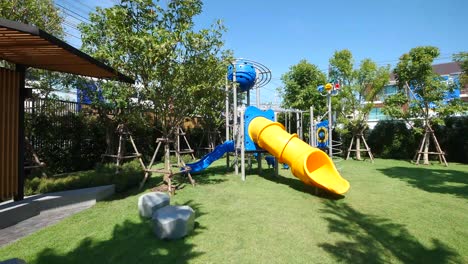 Colorful-Children-Playground-In-The-Garden-On-Sunny-Day