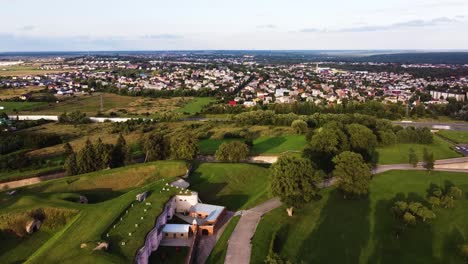 Quick-time-lapse-of-Kaunas-city-over-the-Ninth-fort,-a-historical-place,-in-beautiful-static-drone-aerial-shot-with-highway-and-moving-traffic