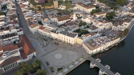 flying-over-the-historical-buildings-of-Tavira,-Portugal-at-sunset
