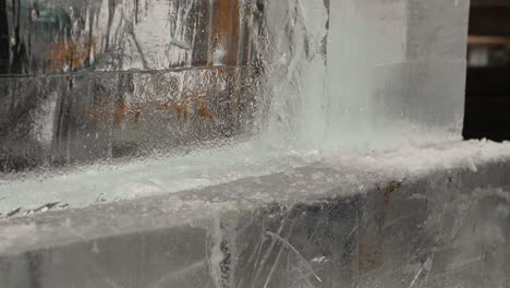 Reciprocating-saw-blade-coming-through-far-side-of-ice-block,-Slow-Motion