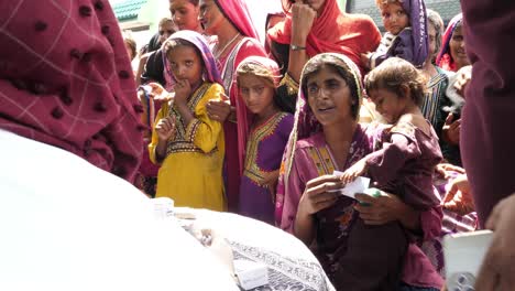 Madre-Con-Un-Niño-Hablando-Con-Un-Médico-Auxiliar-En-El-Campamento-De-Socorro-Por-Inundaciones-En-Sindh,-Pakistán