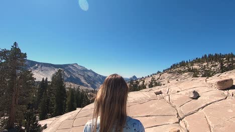 Yosemite-national-park-mountains-domes-women-stands-on-rock-in-front-view-landscape