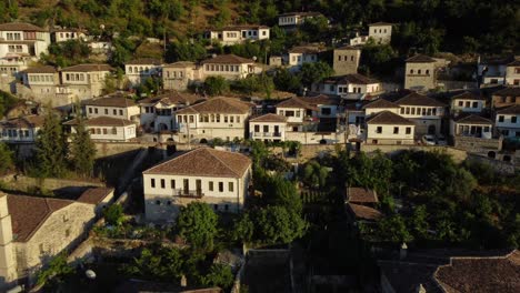 Drone-shot-of-the-Albanian-UNESCO-world-heritage-city-Berat---drone-is-showing-the-old-town-during-sunset