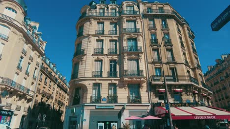 wide-shot-driving-past-brasserie-in-iconic-old-Paris-building-appartement-france