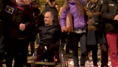 Invalid-man-in-wheelchair-holding-hands-at-the-Stock-Exchange