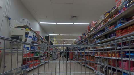 POV-From-Inside-Trolly-Going-Down-Biscuit-Aisle-In-Tescos-During-Christmas