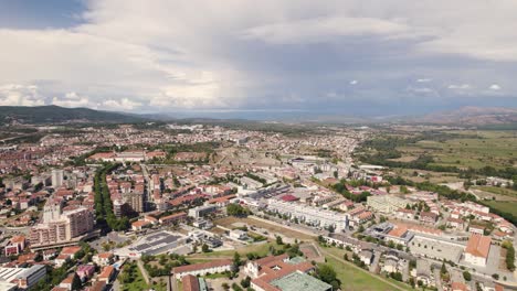 Aerial-High-view-over-City-of-Chaves-Sprawling-in-distance,-Cloudy-day---Portugal