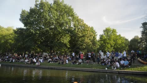 large-group-of-people-gathered-near-a-lake-in-berlin,-germany