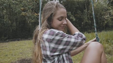 Model-relaxing-on-swing-on-vacation