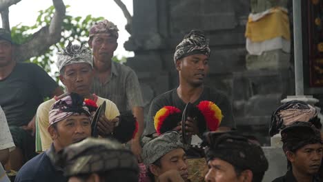 Slow-motion-panning-shot-across-group-of-Balinese-musicians-with-cymbals---percussion-instruments-in-outdoor-event