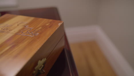 Dolly-across-wooden-book-box-on-table-labeled-The-Holy-Bible